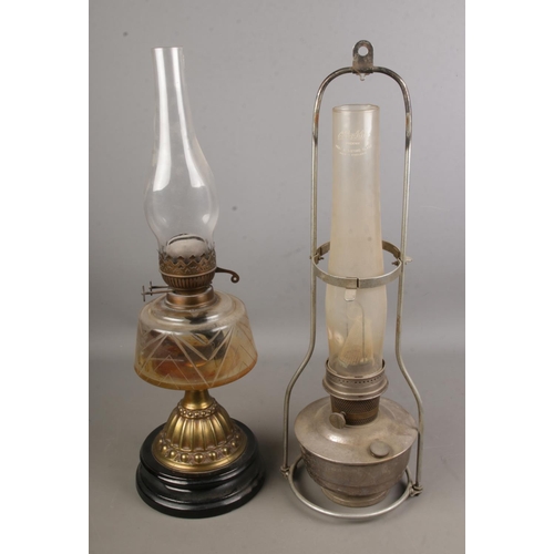 109 - A Victorian brass and glass oil lamp together with a hanging railway oil lamp produced by Aladdin.