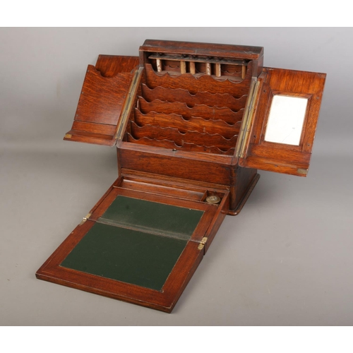 113 - An oak stationary box with bottom draw developing into a writing slope