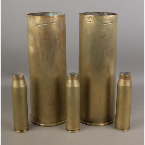 124 - A collection of shell cases including two large examples dates 1989