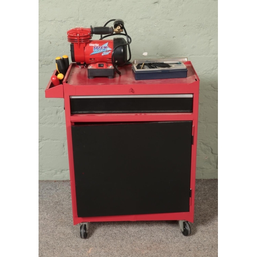 335 - A red and black tool cabinet on casters with contents of assorted tools to include Clarke Wiz Air ta... 