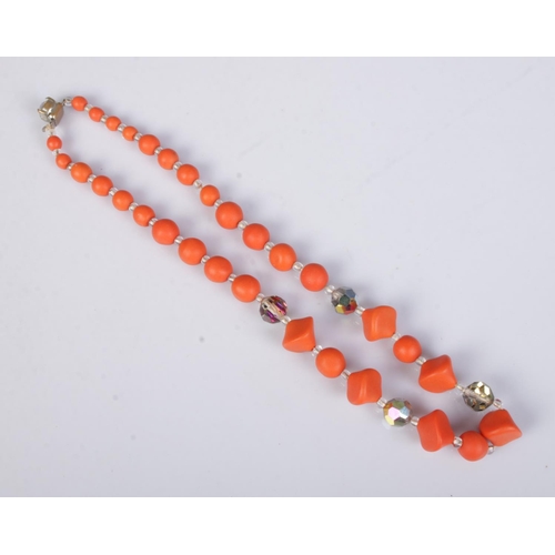 419 - A graduated coral necklaces featuring several clear faceted beads. Approx. length unclasped 44cm.