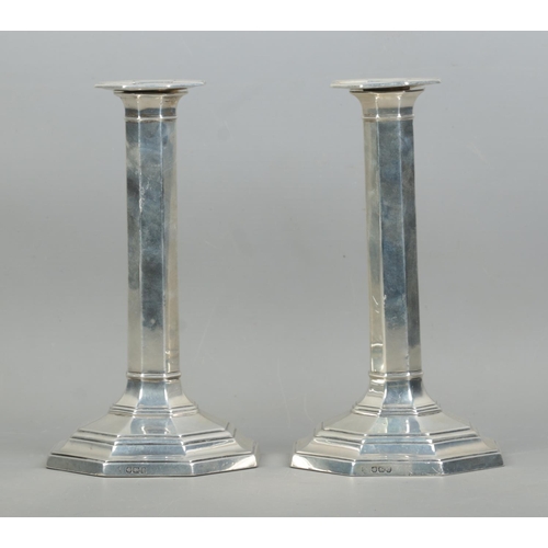 454 - A quality pair of George V silver filled candlesticks of octagonal form, featuring stepped bases. As... 