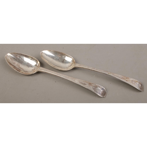 456 - A pair of late Eighteenth Century Georgian table spoons, with floral detailing and 'E' engraved to t... 