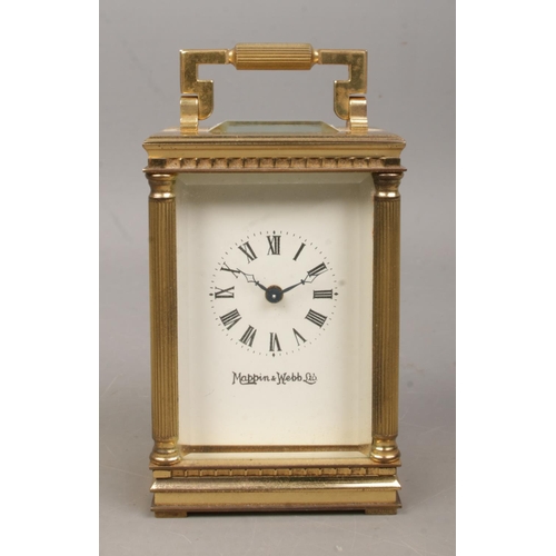 461 - A miniature brass Mappin and Webb carriage clock, with Corinthian column supports to the corners, wh... 