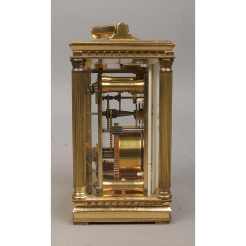 461 - A miniature brass Mappin and Webb carriage clock, with Corinthian column supports to the corners, wh... 