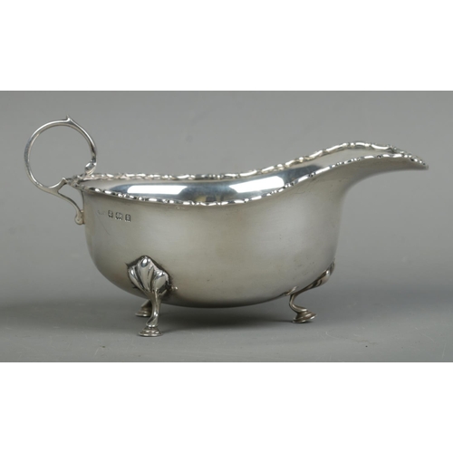 472 - An Edwardian silver sauceboat, with beaded rim raised on three hoofed feet. Assayed for Birmingham, ... 