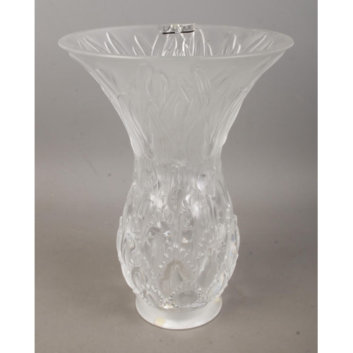 481 - A Lalique frosted glass vase decorated with floral motifs. Approx. height 25cm.