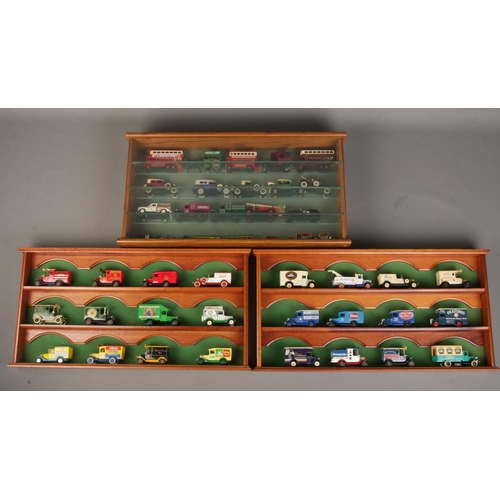 9 - A collection of diecast vehicles in three separate display cases, mostly Lledo Days Gone examples.