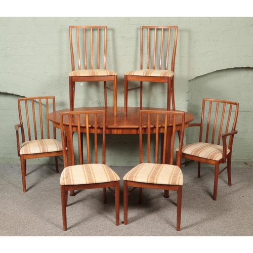 513 - A Mcintosh teak extending dining table with six chairs including two carvers.

Table not extended 
H... 