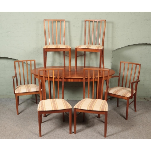 513 - A Mcintosh teak extending dining table with six chairs including two carvers.

Table not extended 
H... 