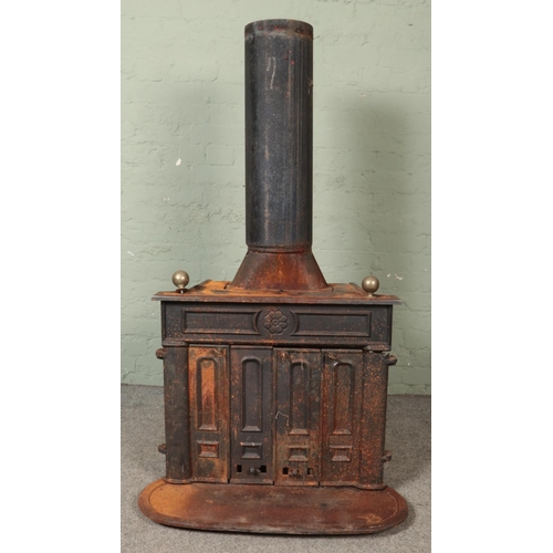 347 - A large cast iron stove, with twin doors to the front. Stamped 'Made in West Germany' to the back.