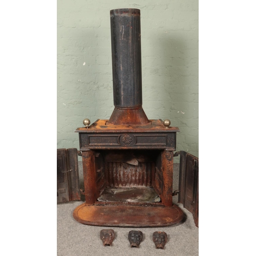 347 - A large cast iron stove, with twin doors to the front. Stamped 'Made in West Germany' to the back.