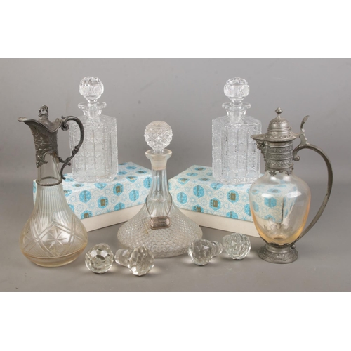 70 - A collection of decanters and claret jugs. Includes two boxed Bohemia examples, four glass stoppers,... 