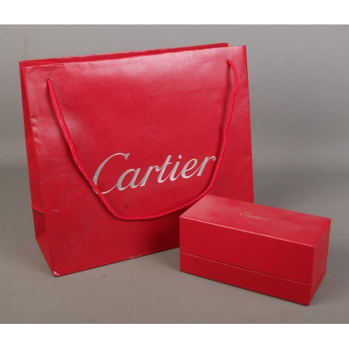 75 - Cartier, an empty sunglasses box along with associated bag.