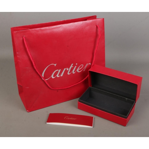 75 - Cartier, an empty sunglasses box along with associated bag.