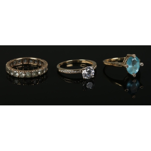 431 - Three Gold rings, to include large solitaire ring set with central paste stone and shoulders, 375 go... 