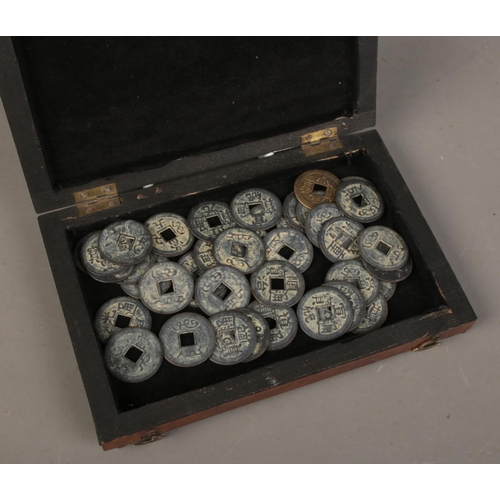 77 - An antique rosewood box with collection of Chinese coins/tokens.