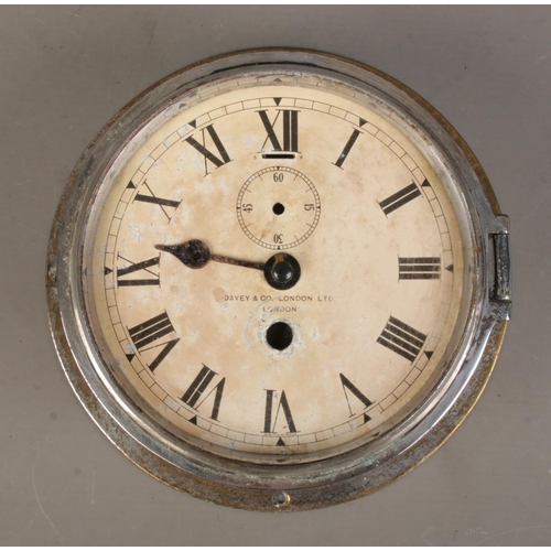 79 - A chrome plated ship's bulk head clock by Davey & Co, London.