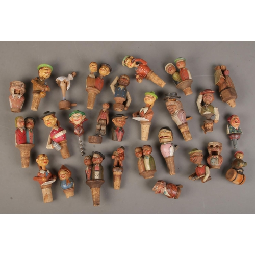 80 - A good quantity of carved wooden novelty bottle stoppers.