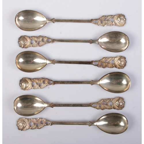 493 - A set of six continental silver demitasse spoons. Having rose decoration finials and stamped 800. 10... 