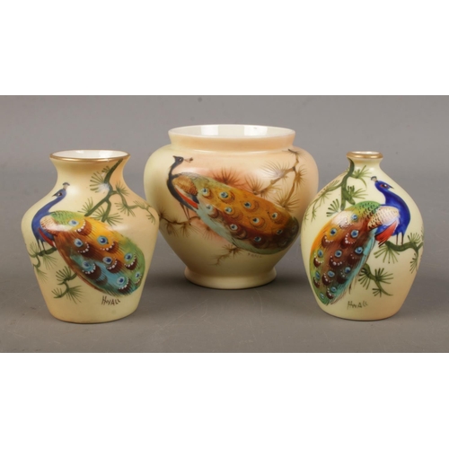 500 - Three small Locke & Co Worcester vases. All hand painted and decorated with a peacock. Signed H Wall... 