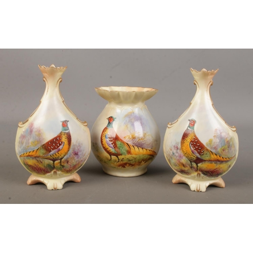 505 - A pair of Locke & Co Worcester vases along with one other. All hand painted and decorated with a phe... 