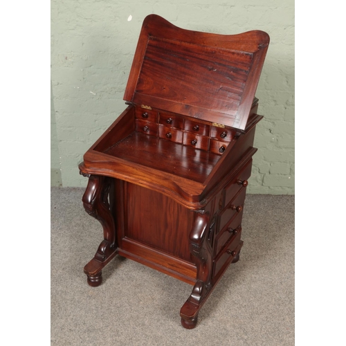 525 - A mahogany davenport with leather inset top