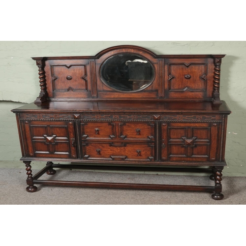 526 - A carved oak mirror back sideboard with geometric design on barley twist supports and drop handles