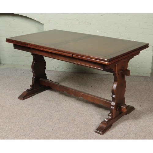 556 - A oak refectory table with six leather upholstered chairs