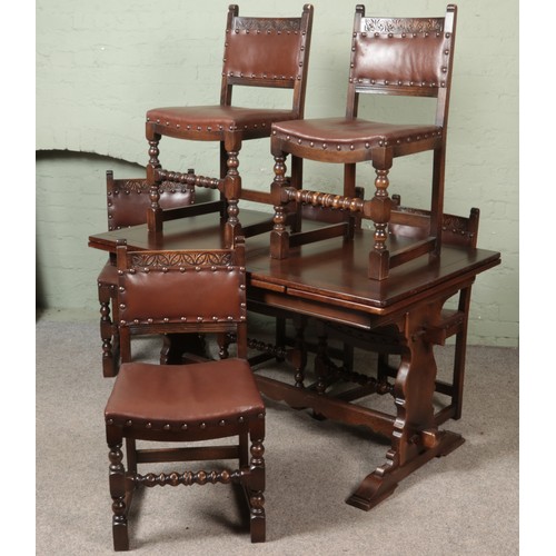 556 - A oak refectory table with six leather upholstered chairs