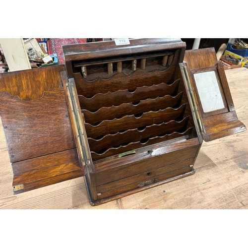 113 - An oak stationary box with bottom draw developing into a writing slope