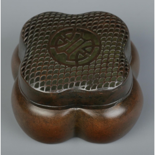 10 - A Chinese bronze hand warmer of lobed form, having pierced cover. Character marks to base. 4cm x 6.5... 