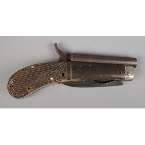 108 - A 19th century percussion knife pistol. Having chequered grip, folding knife and pull down trigger. ... 