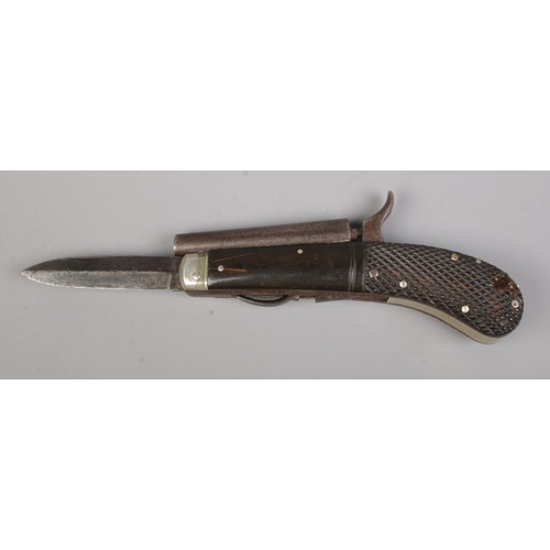 108 - A 19th century percussion knife pistol. Having chequered grip, folding knife and pull down trigger. ... 