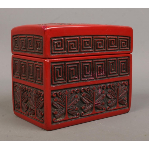 11 - A Chinese cinnabar lacquer card box. The cover decorated with a landscape scene. 9cm x 11cm x 6.5cm.