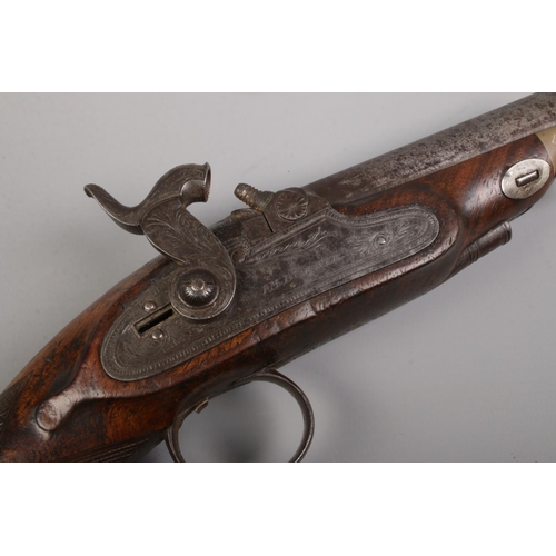 111 - A pair of 19th century percussion pistols. The lock plates marked for IM Burnie. Total length 21cm. ... 