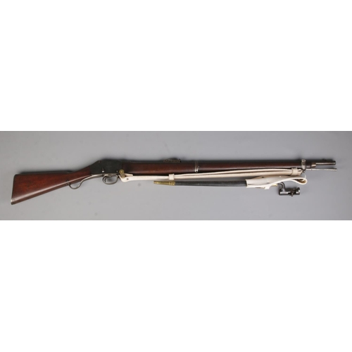 113 - A Victorian Enfield Martini Henry MkIII rifle. Dated 1884. With sling and socket bayonet in scabbard... 