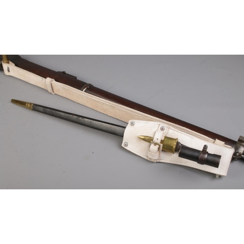 113 - A Victorian Enfield Martini Henry MkIII rifle. Dated 1884. With sling and socket bayonet in scabbard... 