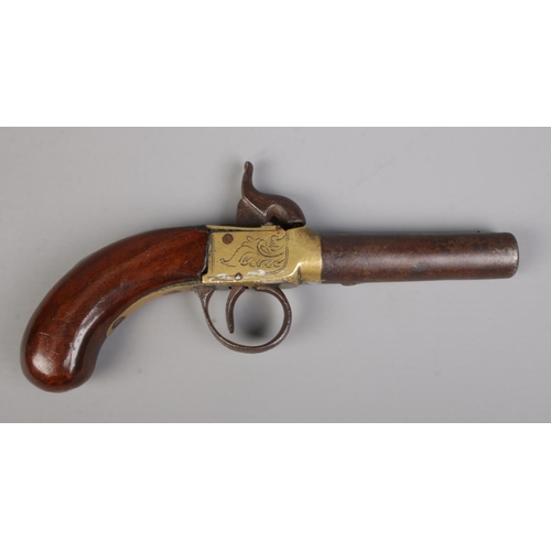 117 - A 19th century percussion cap pistol with cylindrical barrel. Length 18cm. CANNOT POST OVERSEAS.