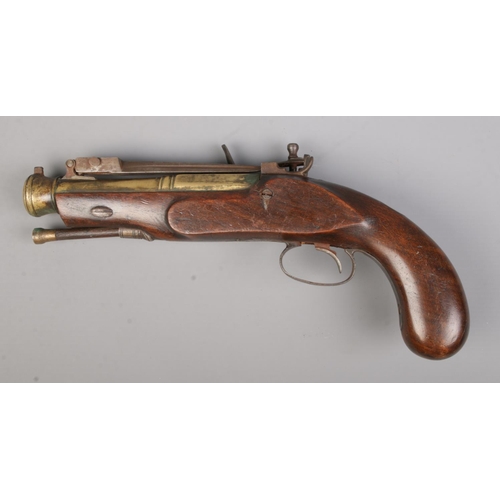 120 - A flintlock pistol with flick over knife to top of barrel. Total length 28cm. CANNOT POST.