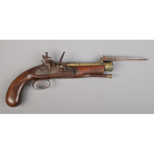 120 - A flintlock pistol with flick over knife to top of barrel. Total length 28cm. CANNOT POST.