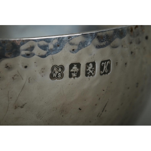 146 - An Arts & Crafts silver bowl, raised on three curvilinear supports on circular base. Monogramed to t... 