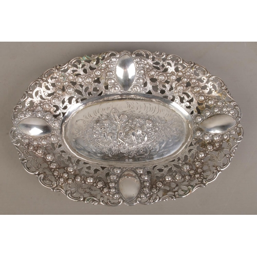 149 - An early 20th century German silver dish. Having pierced and floral border and central panel depicti... 