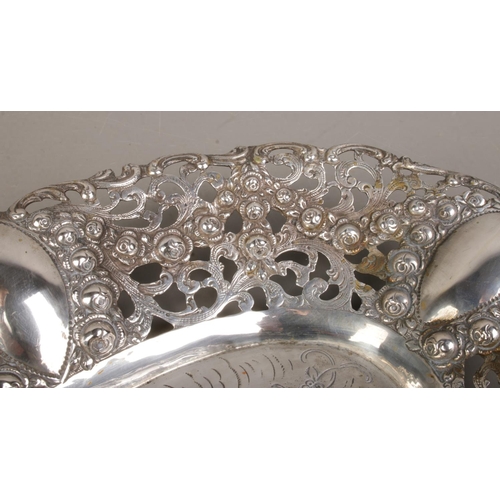 149 - An early 20th century German silver dish. Having pierced and floral border and central panel depicti... 