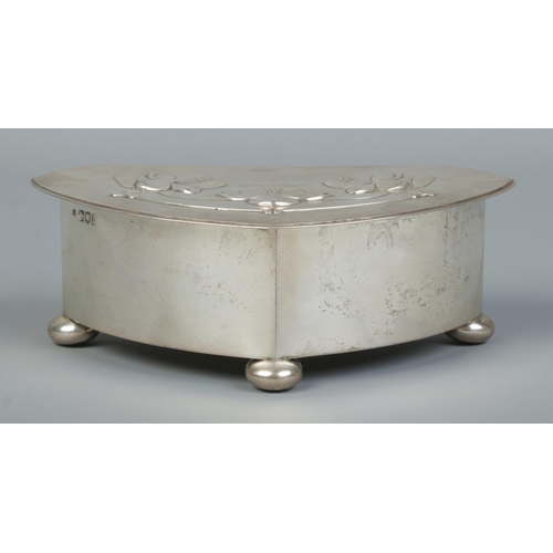 157 - An Art Nouveau silver lidded box raised on three bun feet. Assayed London 1903. 298g. Height 6cm, Wi... 