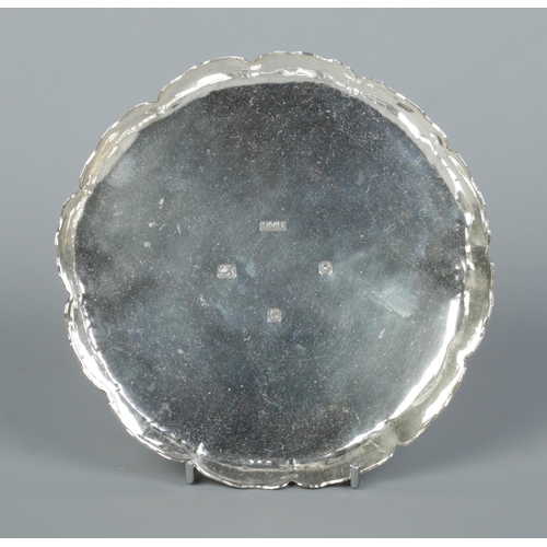 158 - A heavy silver shallow dish with scalloped edge. Assayed London 1988 by Dorothy May Budd. Diameter 1... 