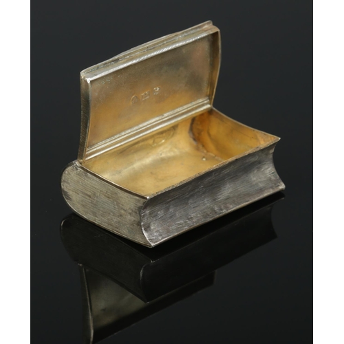 165 - A George III silver snuff box in the shape of a book. The front cover engraved after James Gillray; ... 