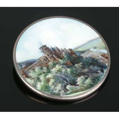 176 - A continental silver and enamel brooch decorated with a landscape scene and castle. Stamped 800 to b... 