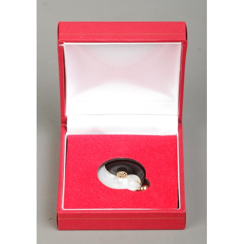 204 - A 14ct gold, mother of pearl and onyx Yin Yang pendant. Having central Hanzi characters. Diameter 2.... 