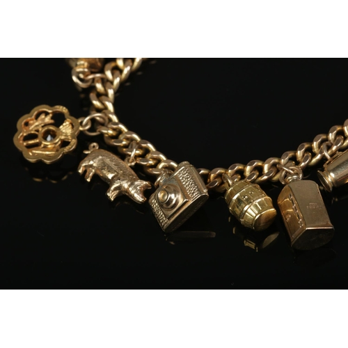 207 - A 9ct gold charm bracelet with mostly 9ct gold charms. Gross weight 36.54g.